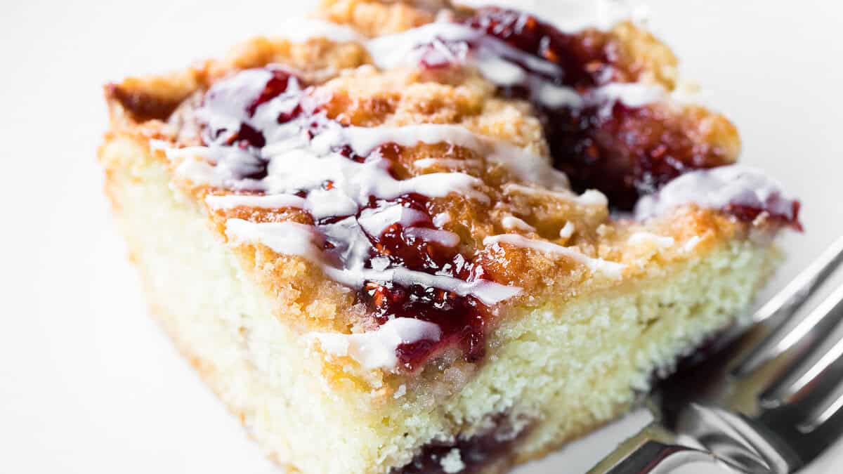 A close up image of a slice of raspberry coffee cake.