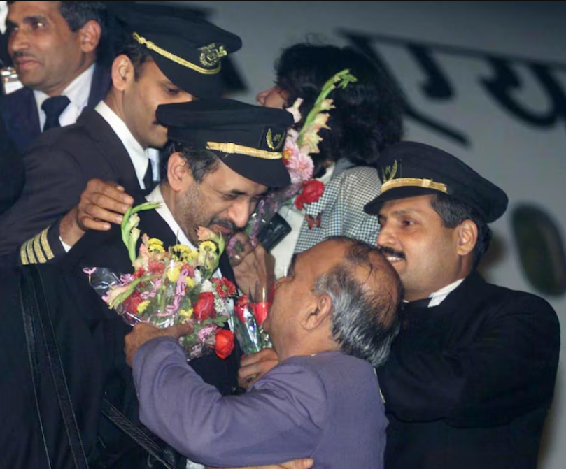 Crew members of the hijacked Indian Airlines plane are greeted by their colleagues at New Delhi airport on December 31. Image Reuters