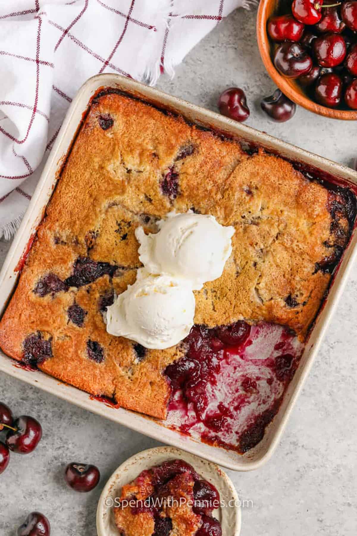 Cherry cobbler on a plate with scoops of ice cream