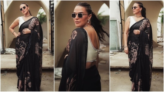 Recently, Neha Dhupia stunned everyone in a stunning black saree embellished with a bold floral print, which was perfectly paired with a chic white sleeveless V-neck blouse. She enhanced the look with black square sunglasses, a statement choker and matching earrings, thereby giving major ethnic fashion goals. (Instagram)