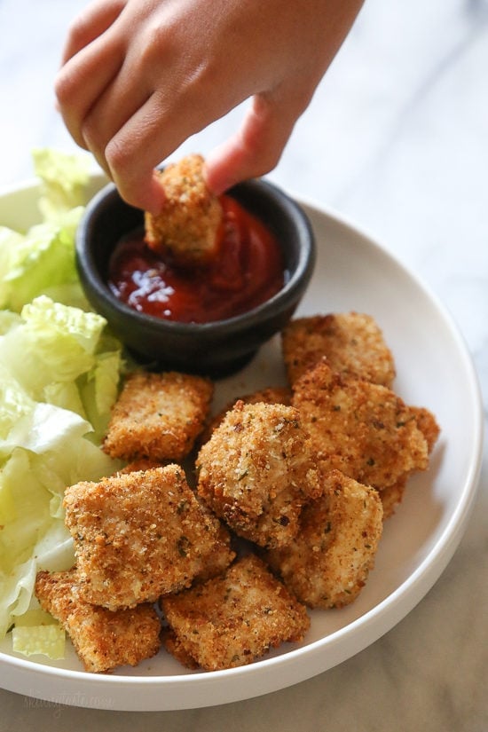 Dipping chicken nuggets in ketchup