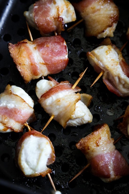 Bacon Wrapped Chicken Bites are the easiest appetizer since they are made with just TWO ingredients. Using the air fryer, the bacon is crispy on the outside and the chicken is juicy and tender on the inside.