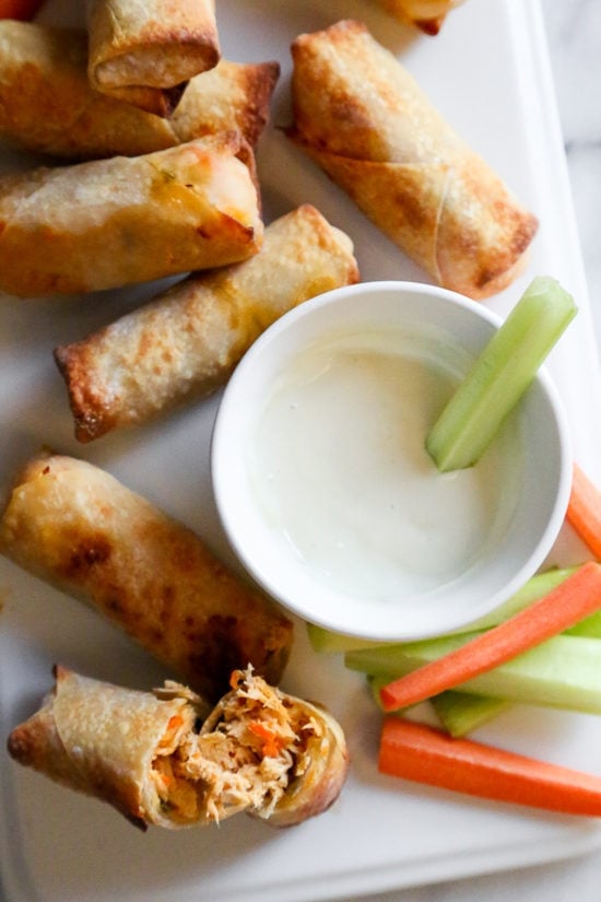 These Buffalo Egg Rolls, filled with shredded boneless chicken breast, carrots, scallions, hot sauce, and blue cheese, are the perfect appetizer. Bake them in the oven or air fryer!