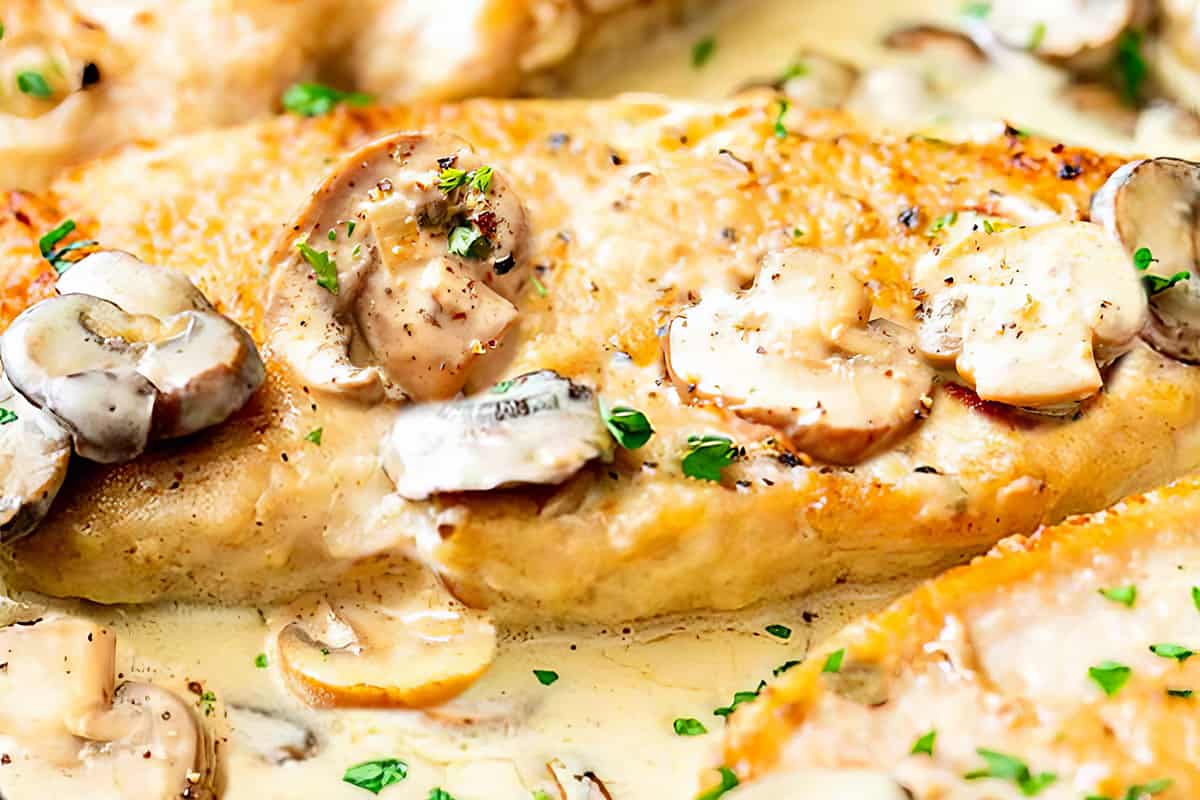 Creamy chicken with mushrooms in a pan ready to serve.