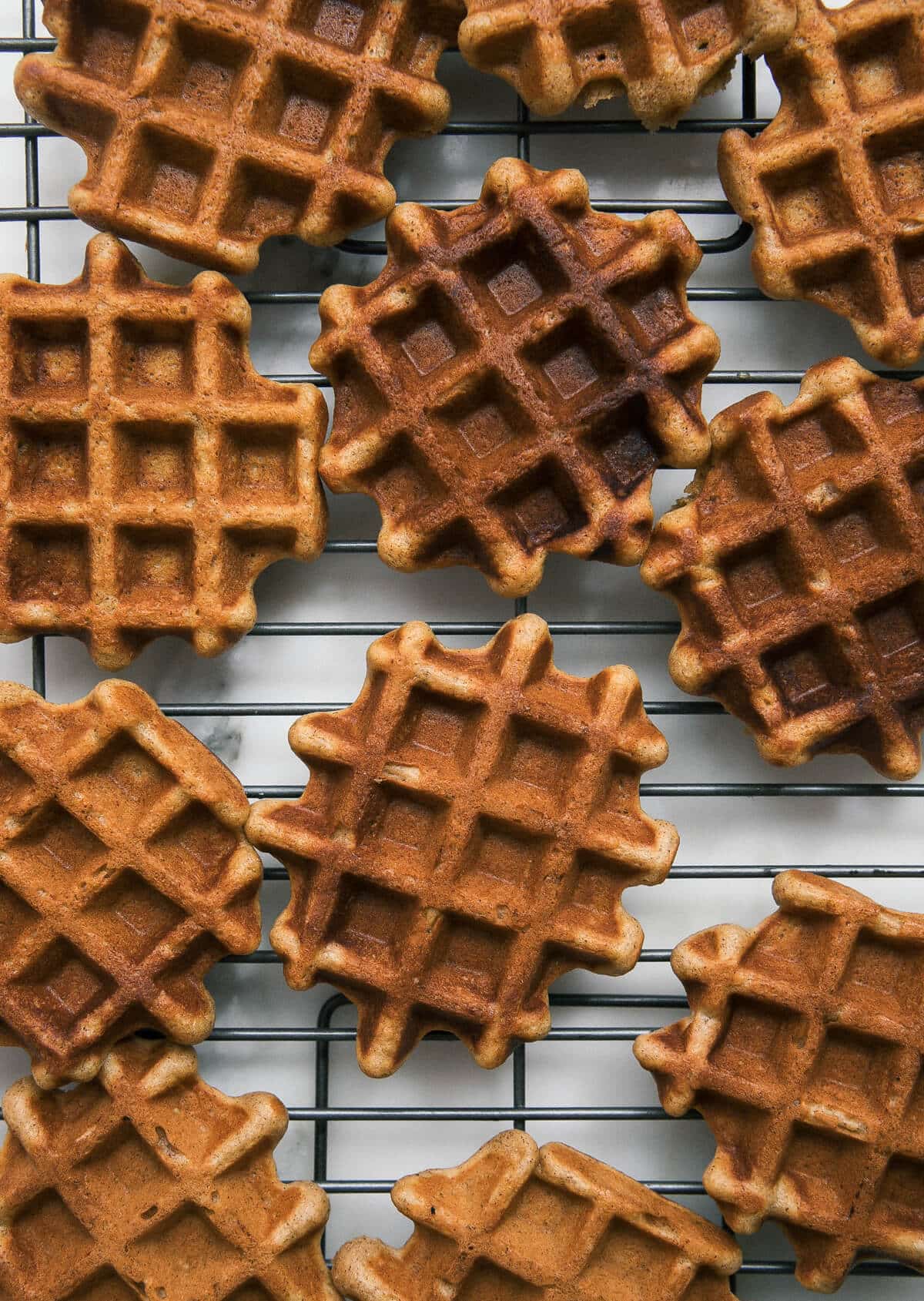 Close-up image of waffles on a wire rack.