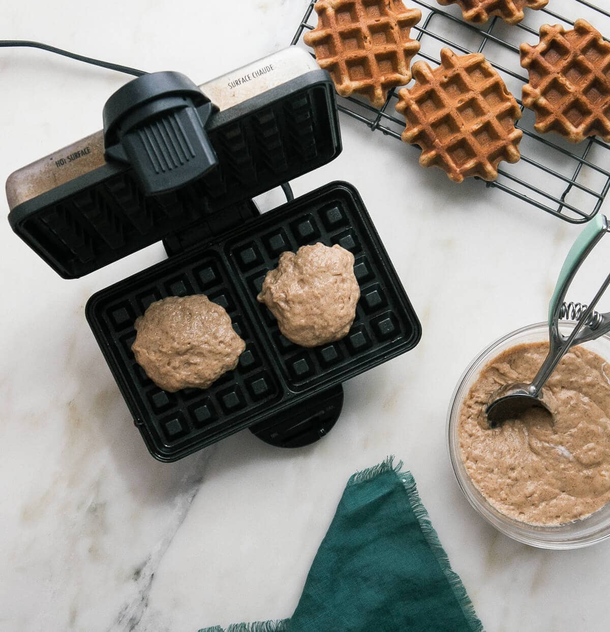 Image of the process of preparing waffle batter in a waffle iron.