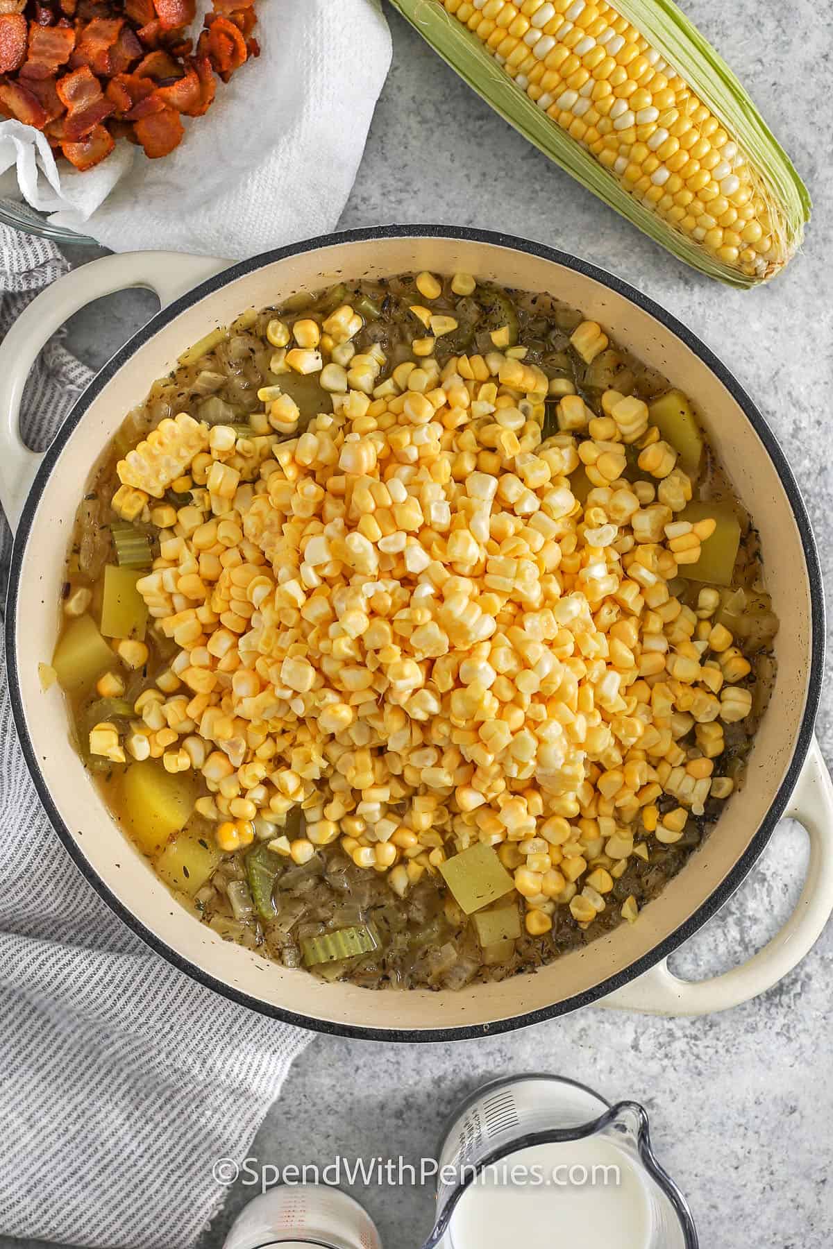 Adding corn to the pan to make easy homemade corn chowder