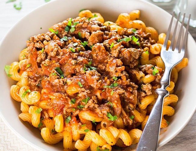 A curly pasta dish topped with Greek-style meat sauce {Makaronia Me Kima}