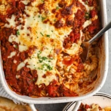 Serving ground beef casserole on a plate with a spoon