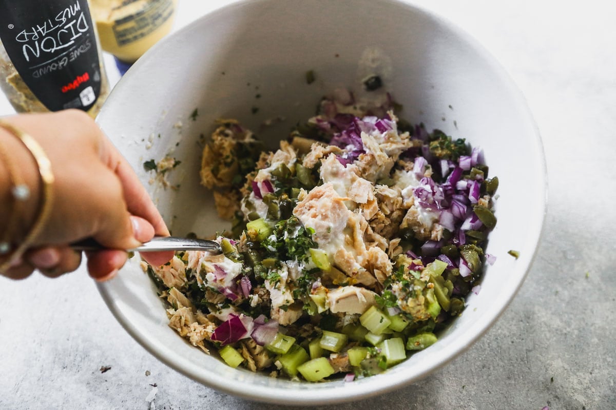 Mixing the ingredients for the tuna salad in a bowl