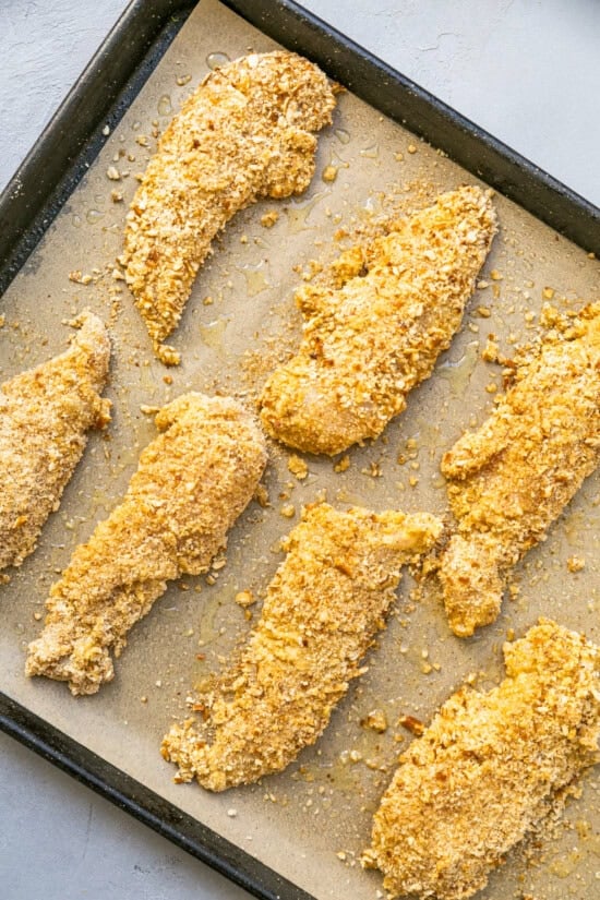 Pretzel-breaded chicken fingers ready to bake.