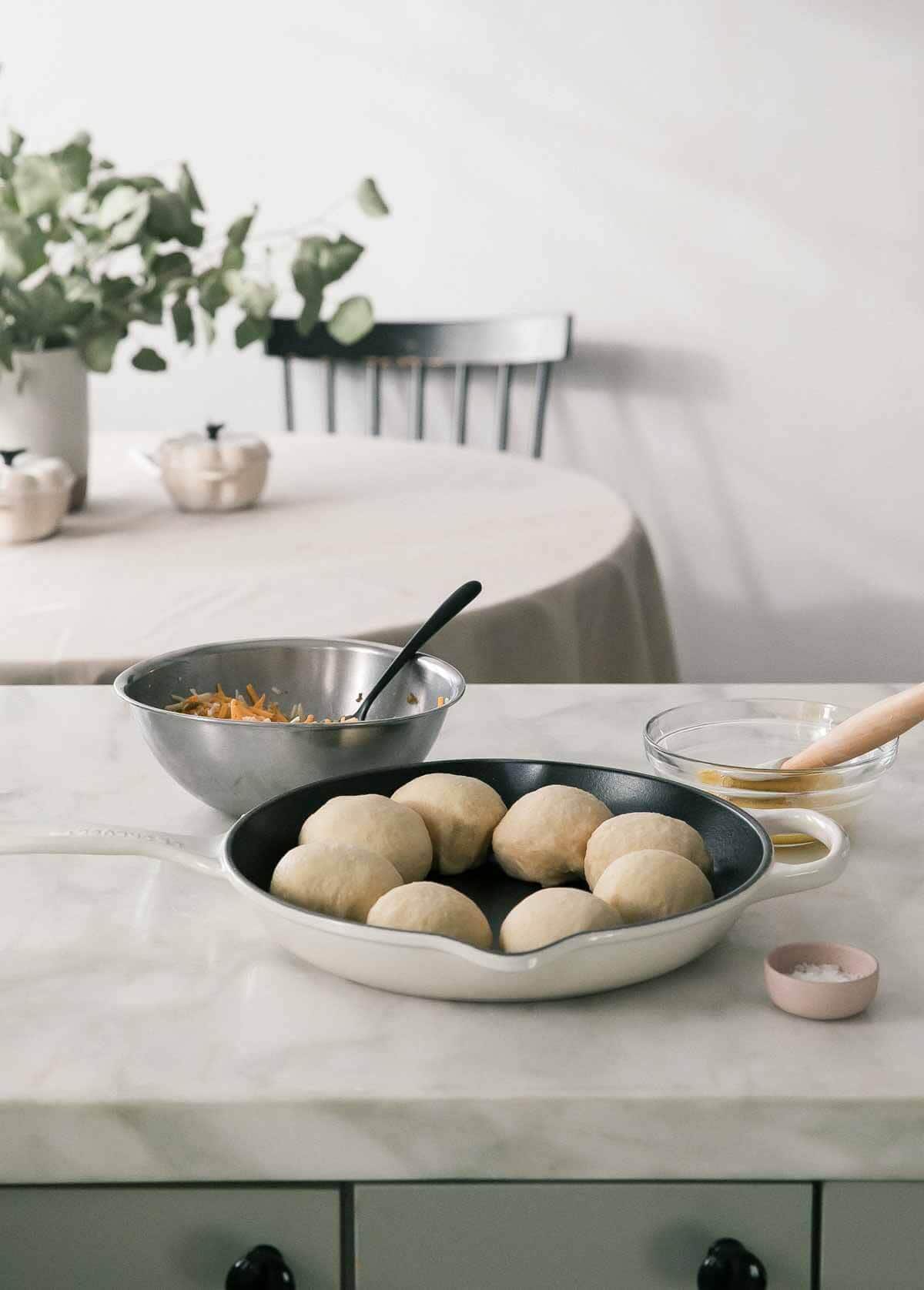 Image of the pretzel dough process in a pan with the ingredients around.