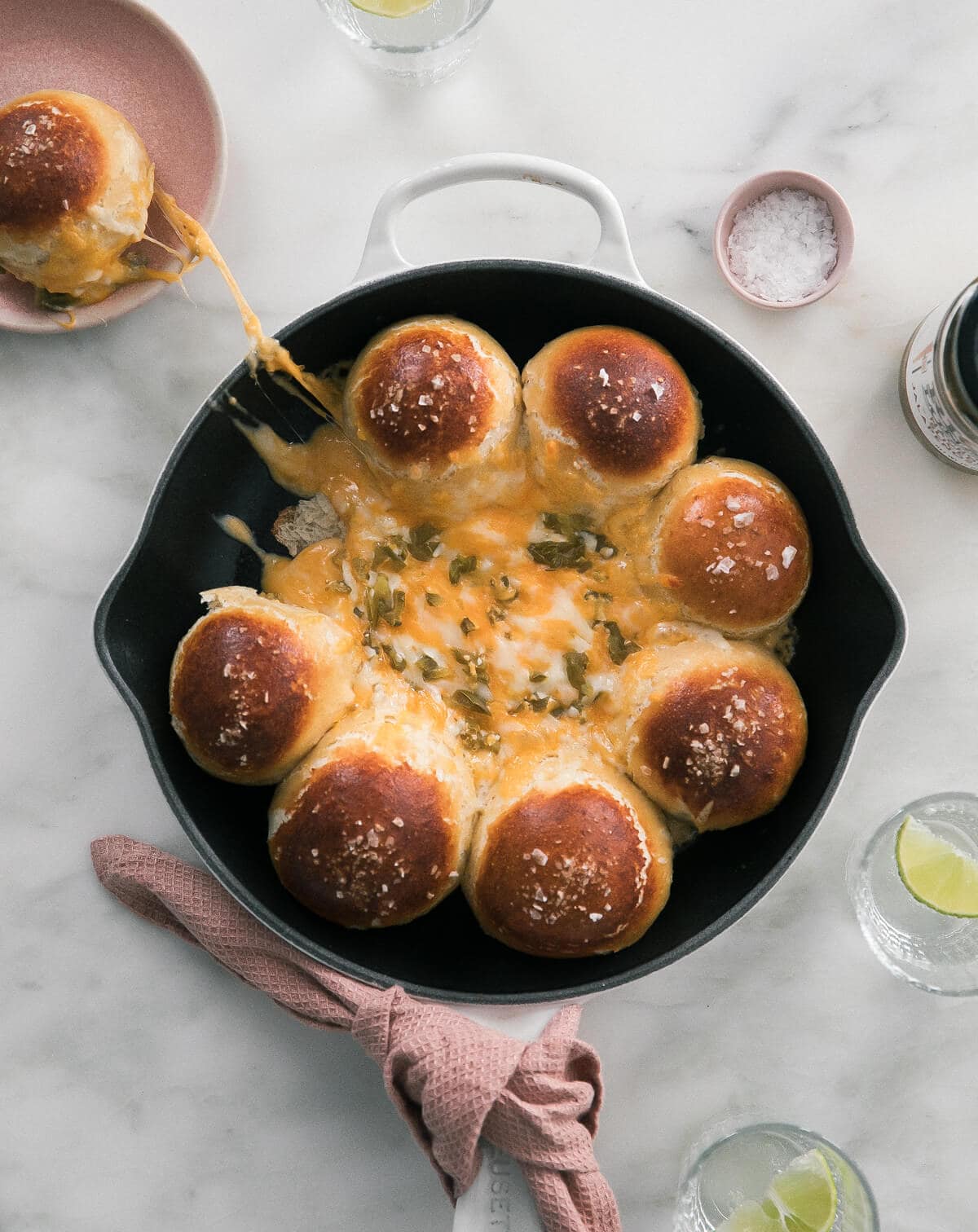 Pretzel Tot Cheese melted in a skillet with a pretzel tot missing.