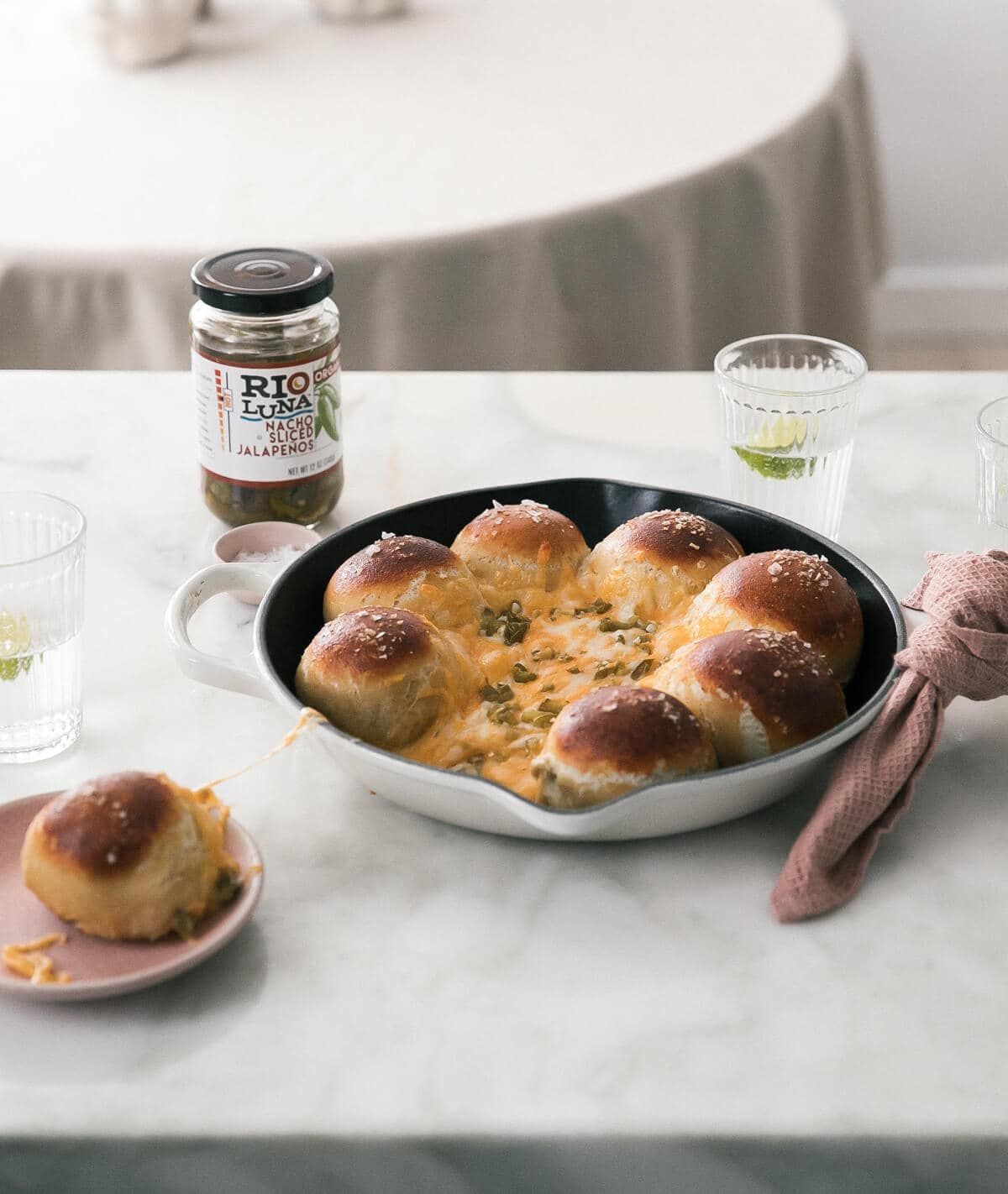 Straight on view of Pretzel Tot Queso Fundido in a pan on the counter.