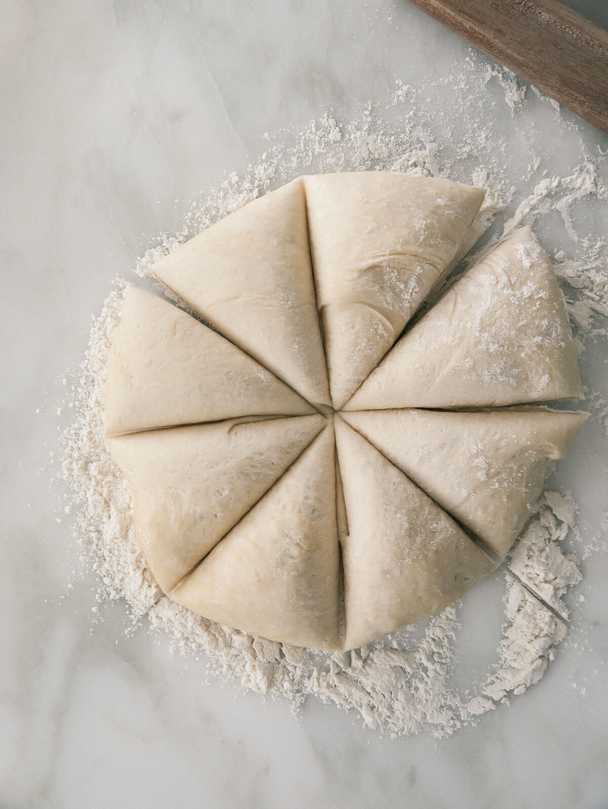 Dough cut into slices on a counter. 