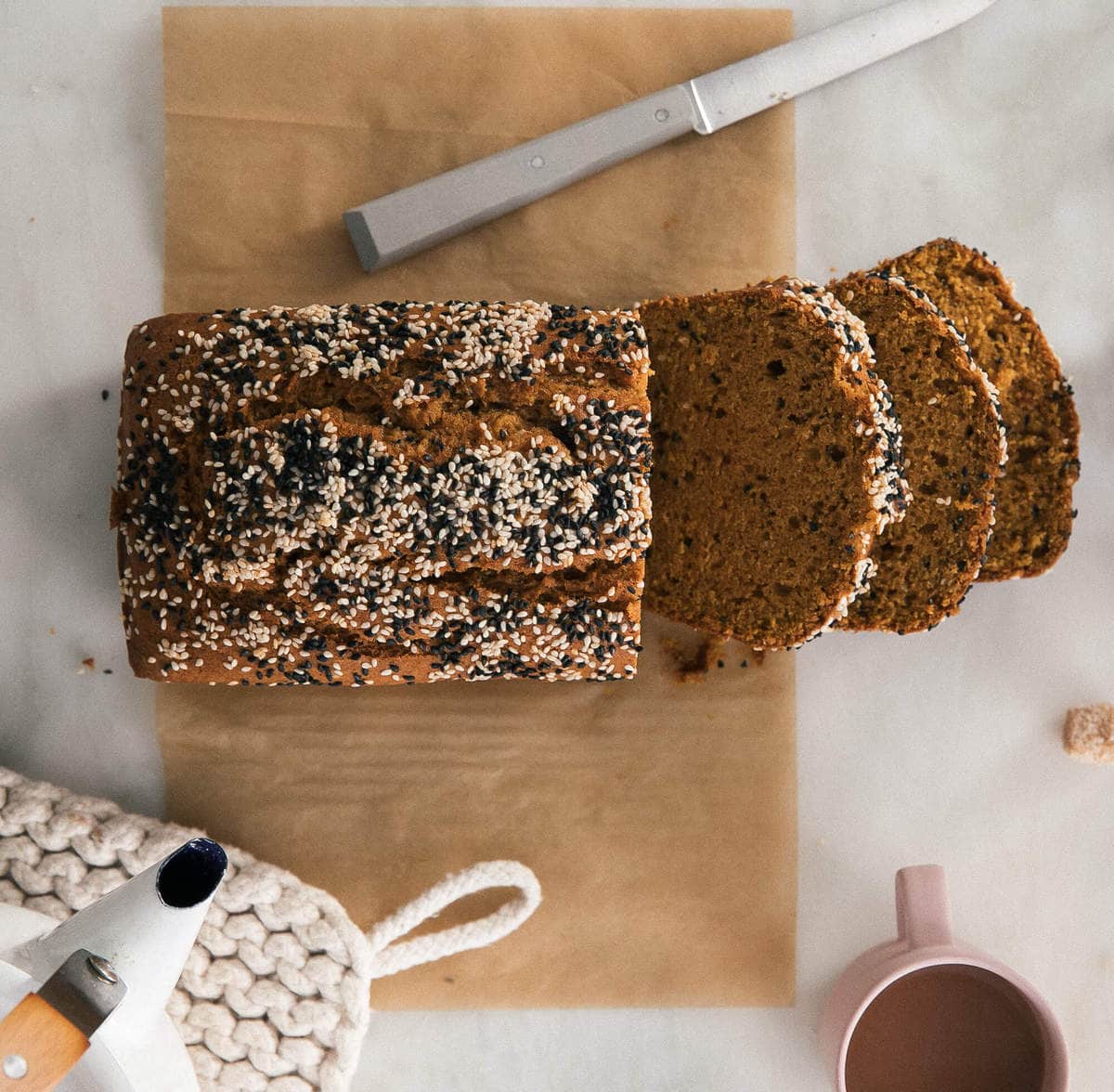 Overhead view of a tahini pumpkin bread with some slices cut out.