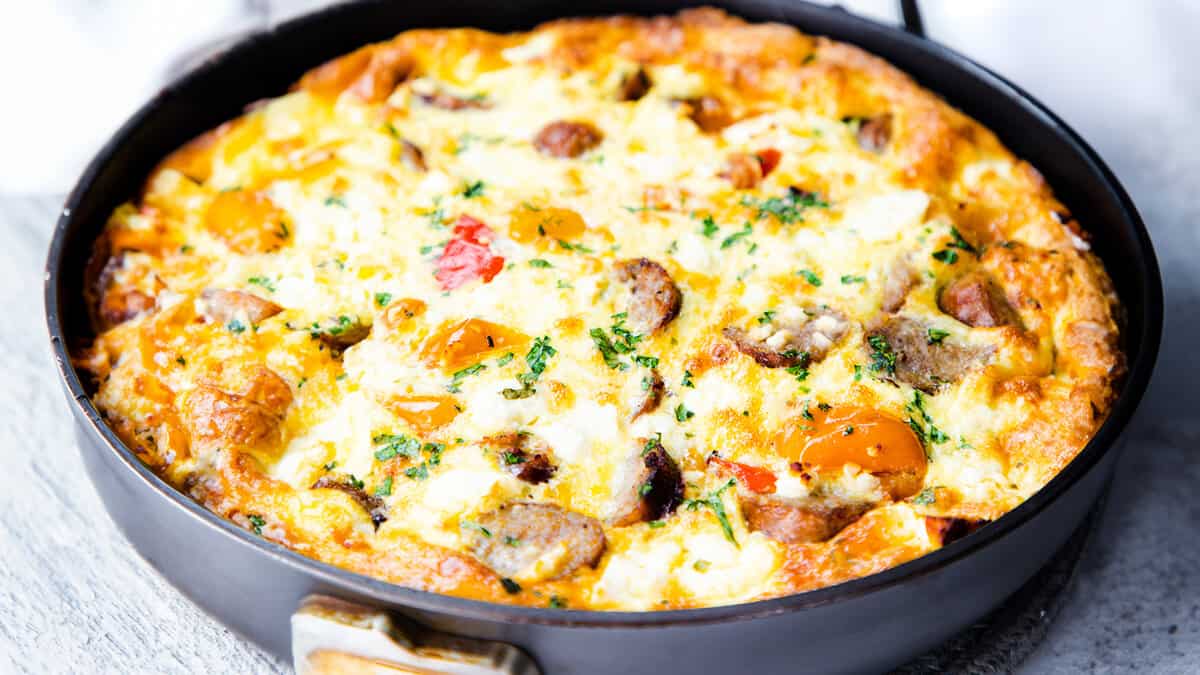 A golden sausage and egg frittata with peppers and feta cheese.