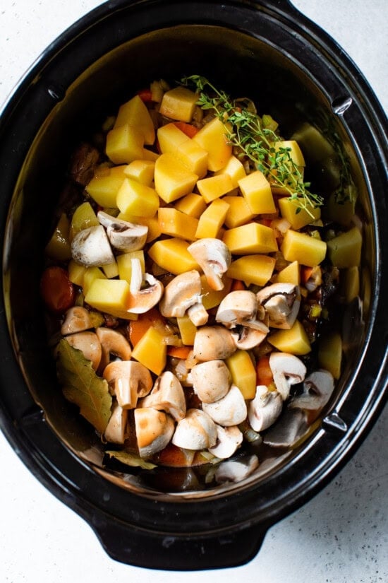 Slow cooker with meat, potatoes and vegetables