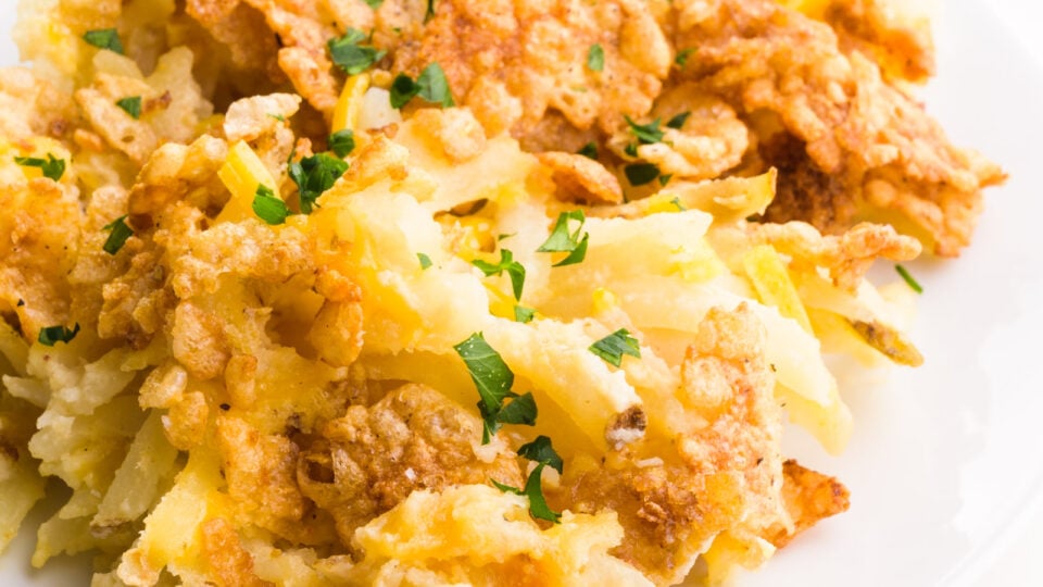 A close-up of cheesy potatoes with a crunchy, buttery cereal topping.