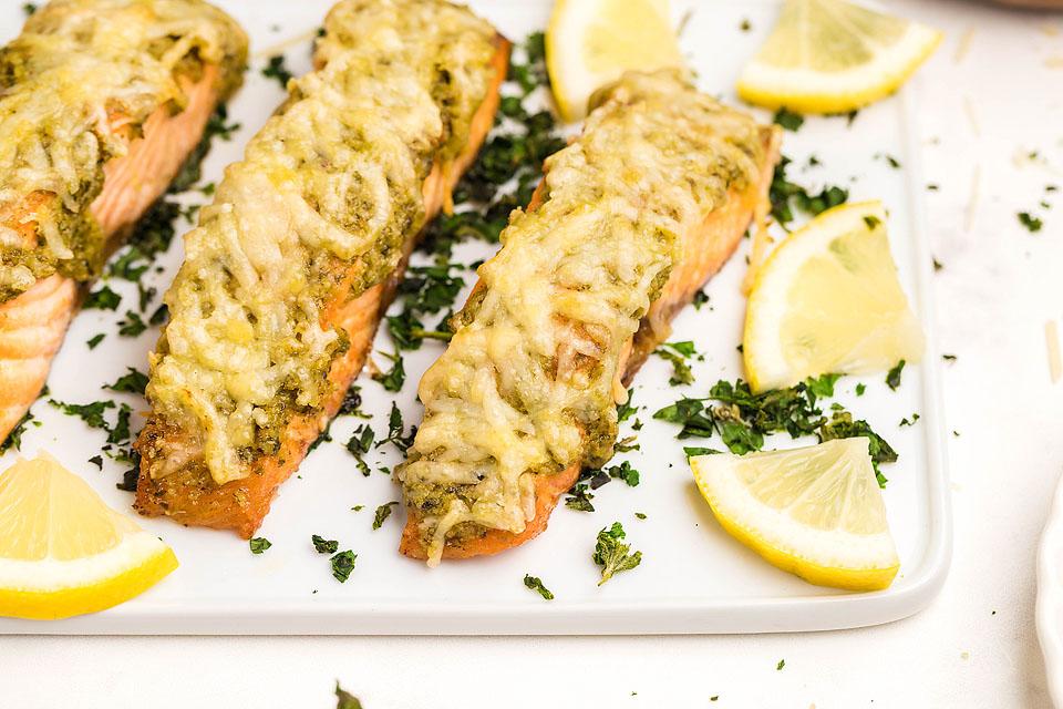 Salmon with parmesan pesto on a tray.