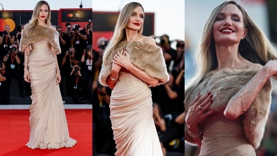 Angelina Jolie graces the 2024 Venice Film Festival in a Tamara Ralph ensemble, consisting of a beige wrap maxi dress paired with a matching fur cape. (Instagram)