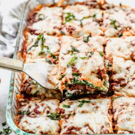 A piece of zucchini lasagna being removed with a spatula.