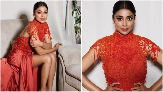 Shriya Saran's latest look is all about glamour. She dazzled in a bright orange ensemble with back detailing, a thigh-high slit and beaded embellishments on the top half, which added a touch of style to her stunning appearance. (Instagram/@shriya_saran)