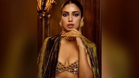 Her glamorous makeup look includes shimmery eyeshadows, winged eyeliner, kohl-lined eyes, mascara-coated lashes, defined brows, blushed cheeks, luminous highlighter, contoured cheekbones, and a nude lipstick shade. (Instagram/@bhumipednekar)