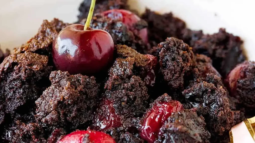 A very close image of a chocolate cherry cake in a bowl.