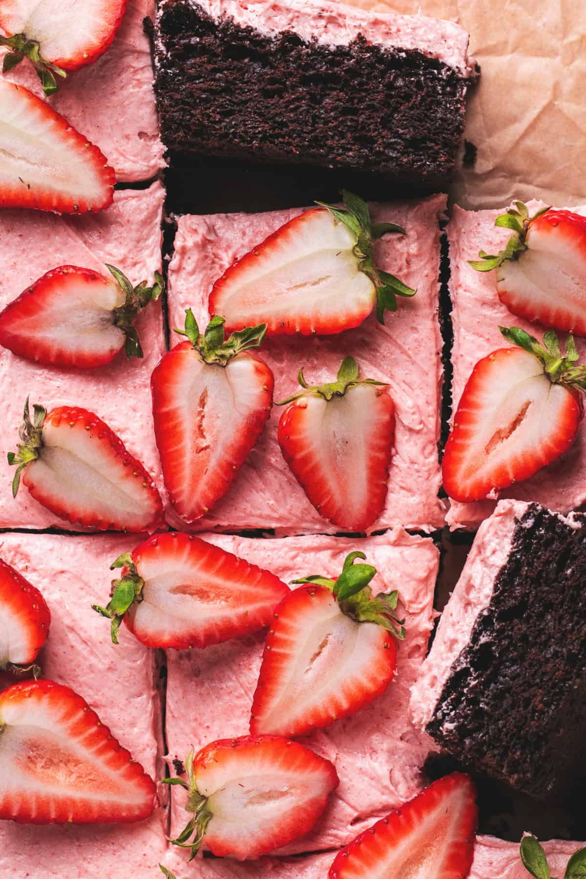 Chocolate cake with strawberry frosting and fresh strawberry halves