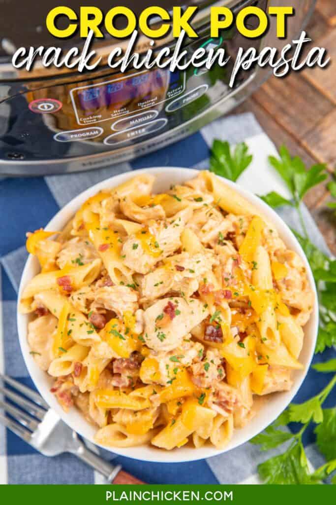 Bowl of pasta with chicken and crack on a tablecloth with text overlay