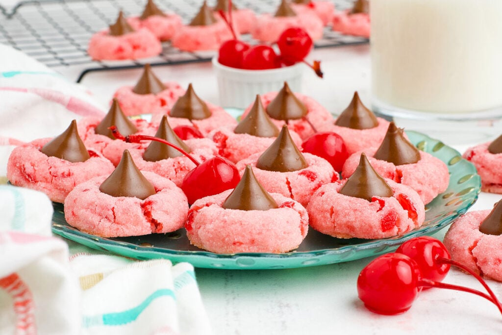 Chocolate and cherry cookies on a green plate.