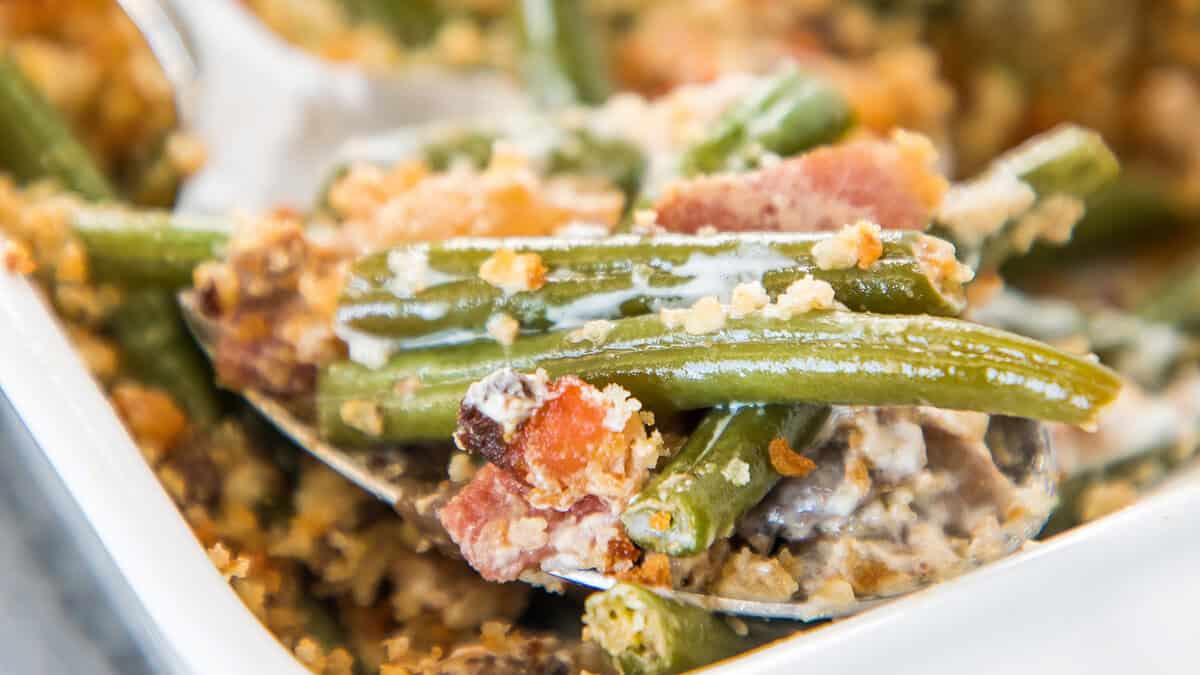 Green Bean Casserole with Bacon Served with a Spoon.