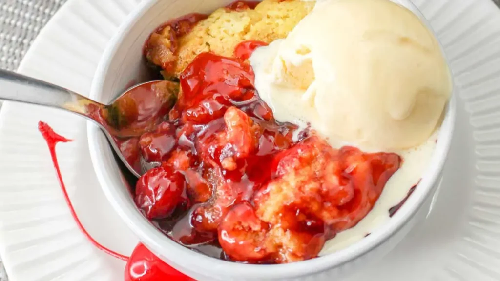 Slow Cooker Cherry Pie in a Bowl with Cherry Sauce and Vanilla Ice Cream.