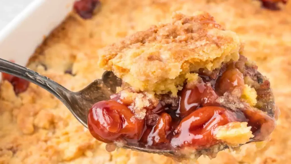 A close up image of a scoop of Cherry Cobbler.