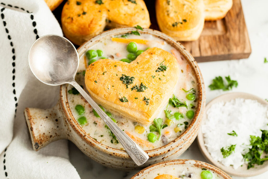 A bowl of chicken soup with heart-shaped puff pastry.