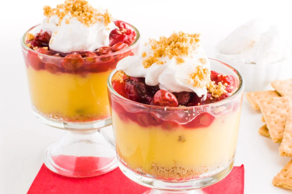 Two glasses of layered vegan cherry vanilla parfait.