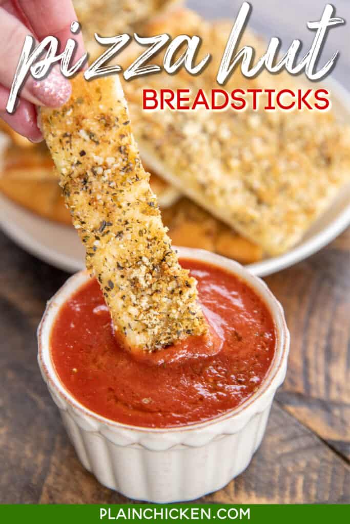 Dipping breadsticks in pizza sauce