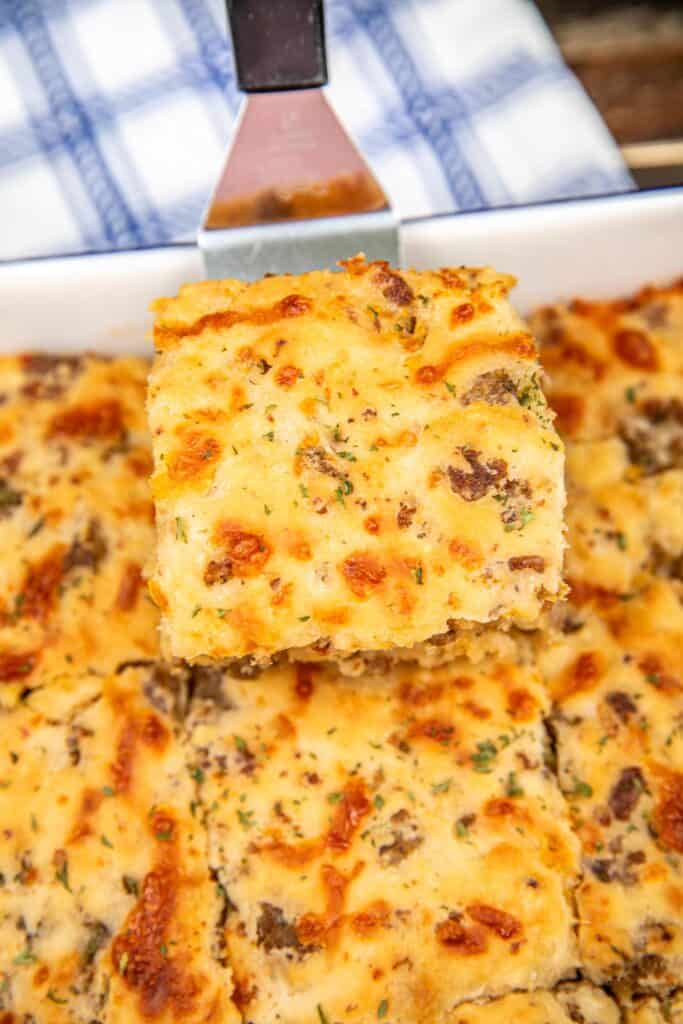 Butter, sausage and cheese biscuits dipped in a spatula