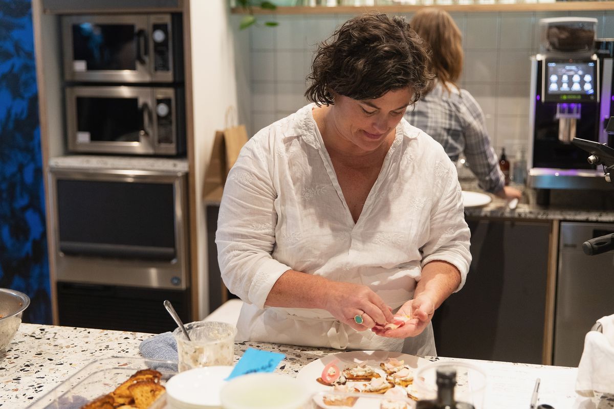 Chef Renee Erickson prepares dishes at a WeWork and James Beard Foundation dinner.