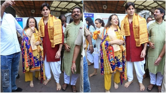 Sidharth Malhotra was dressed in a striking red kurta with a white dhoti and was all smiles alongside his mother, Rimma Malhotra, as they were photographed at the Siddhivinayak Temple. (HT Photo/VarinderChawla)