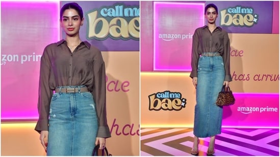 Khushi Kapoor wore a denim skirt with a brown belt, paired with a tucked-in brown net shirt. She completed her chic look with nude heels, an animal print bag and her hair styled in a sleek bun. (HT Photo/VarinderChawla)