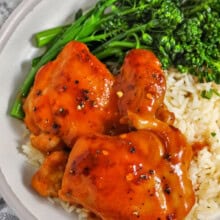 Close-up of chicken with apricot on a plate with rice