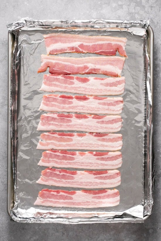 Place cold bacon on a rimmed bacon sheet.