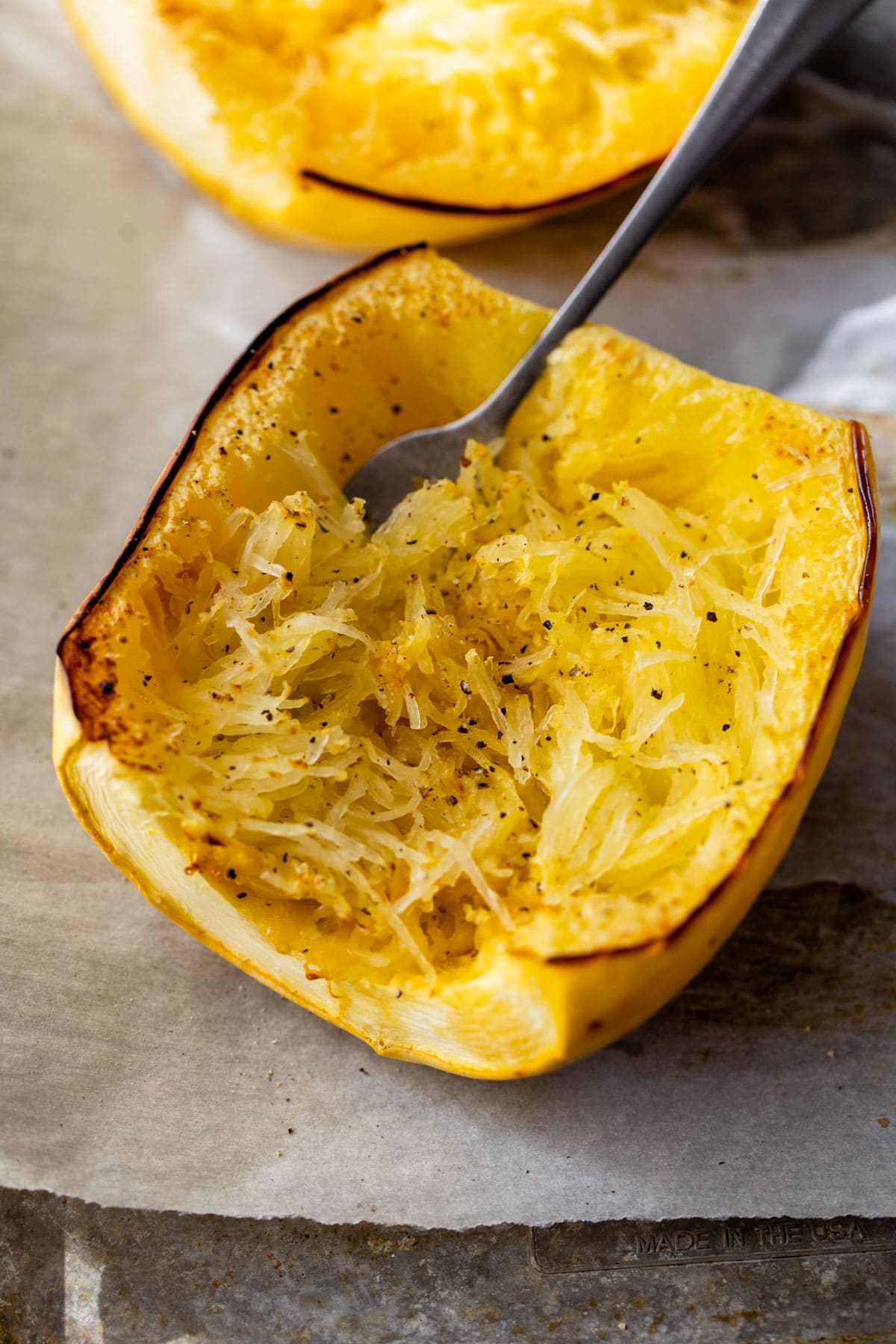 Using a fork to shred roasted spaghetti squash