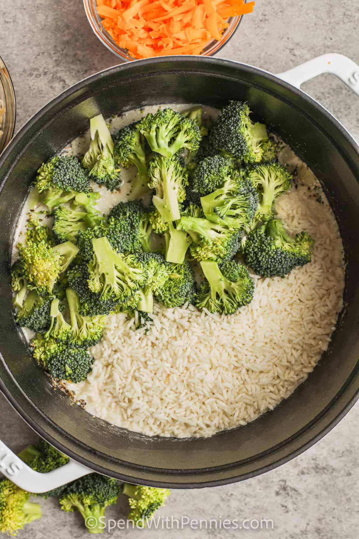 Adding broccoli to the pot to make chicken and broccoli rice casserole