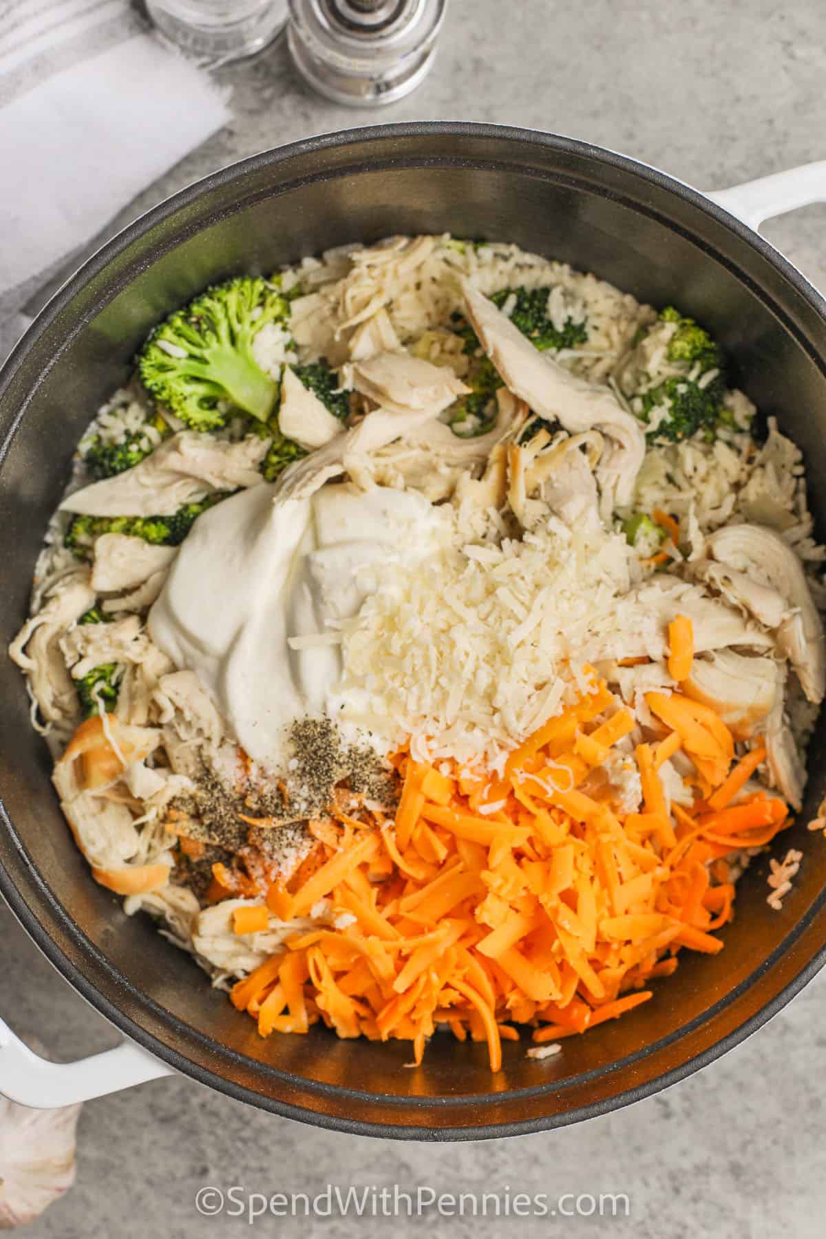 Adding ingredients to the pot to make chicken and broccoli rice casserole