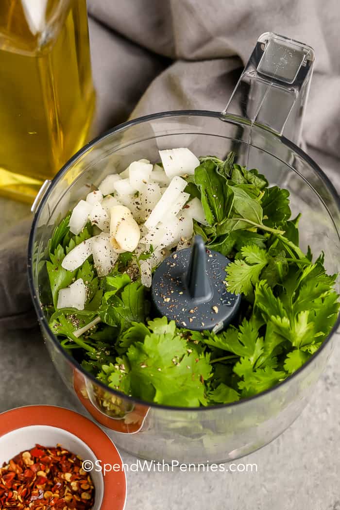 Chimichurri sauce ingredients in a food processor before blending