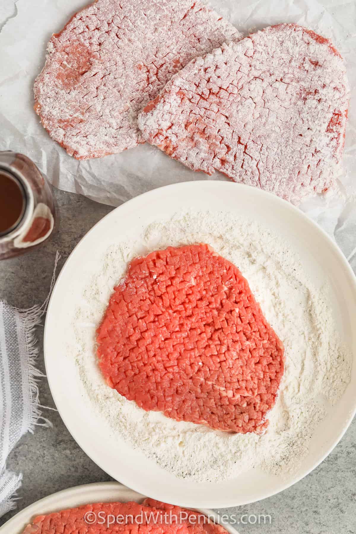 Coat the steak with flour to make a cubed steak with balsamic onion sauce