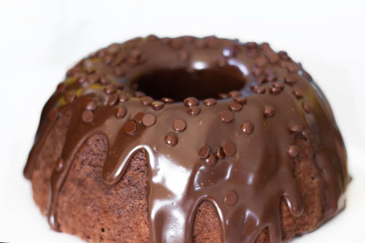 A chocolate Bundt Cake with a sponge cake covered with chocolate chips.